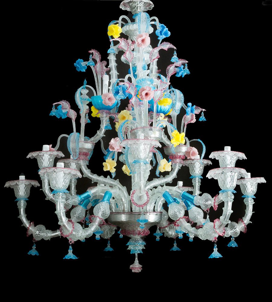 Large Venetian chandelier, multicoloured and transparent glass for 15 light, in curved and bowed shape, mouth blown glass, partly canted, decorated with flowers, leaves, branches, spouts finials in red, blue, yellow and pink glass; with several hanging elements on metal strings; later electrification not tested; in perfect condition; Venice around 1900 Large Venetian chandelier, multicoloured and transparent glass for 15 light, in curved and bowed shape, mouth blown glass, partly canted, decorated with flowers, leaves, branches, spouts finials in red, blue, yellow and pink glass; with several hanging elements on metal strings; later electrification not tested; in perfect condition; Venice around 1900